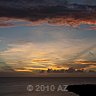 arch of clouds arising from sunset
