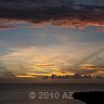 arch of clouds arising from sunset